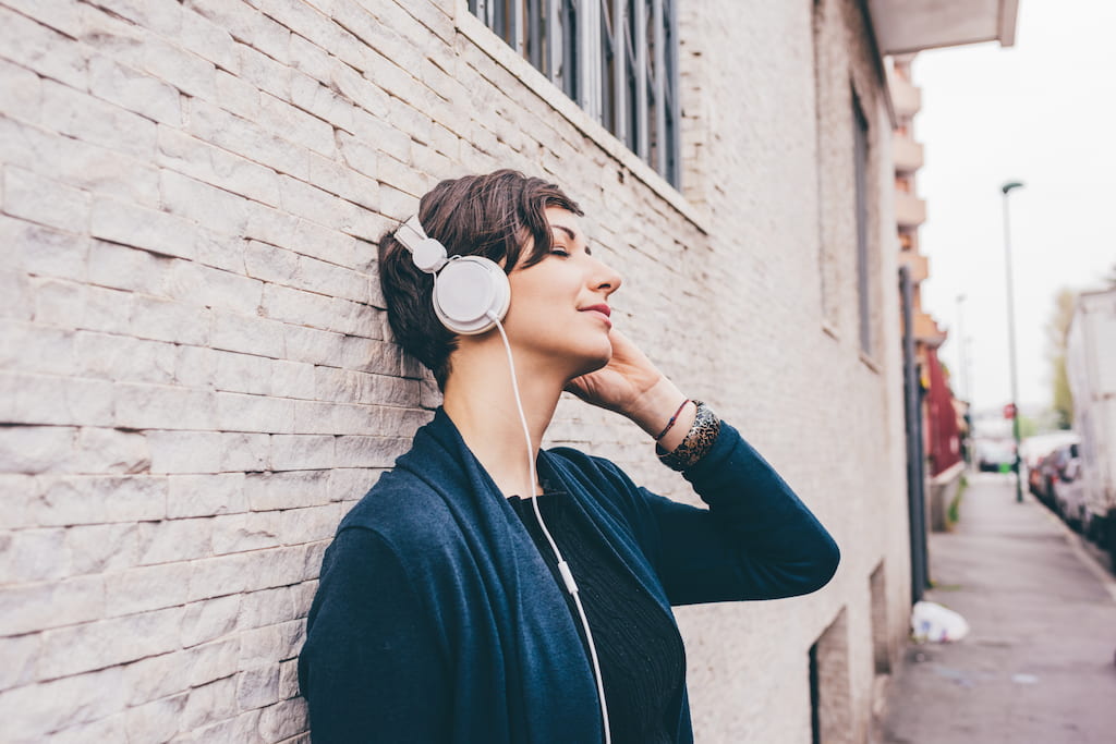 Young woman outdoor listening music